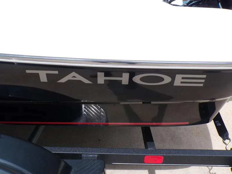 Slide: The Image of 2024 Tahoe T16 boat on trailer, black exterior with bold branding. - 7