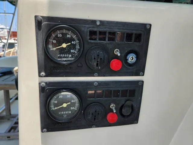 Slide: The Image of Control panel of a 2000 Ocean Cat 49 boat with gauges and switches. - 11