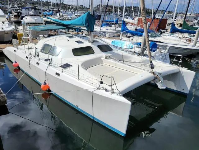 Slide: The Image of 2000 Ocean Cat 49 catamaran docked in a marina. - 18