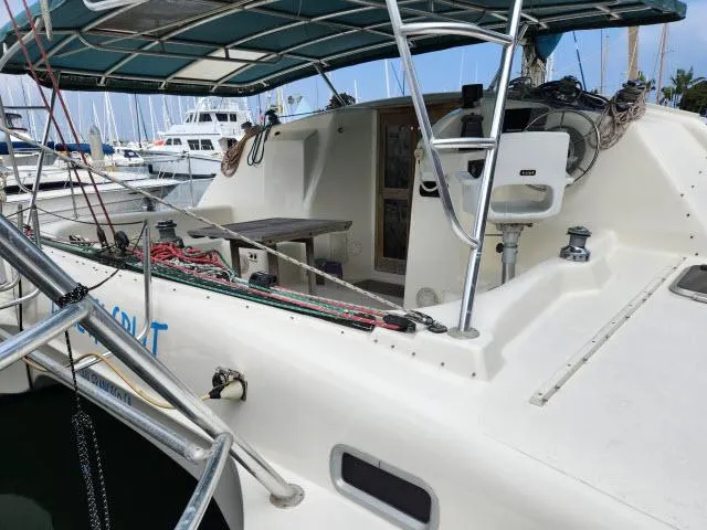Slide: The Image of Ocean Cat 49 sailboat, 2000 model, docked at marina with covered cockpit and seating area. - 2