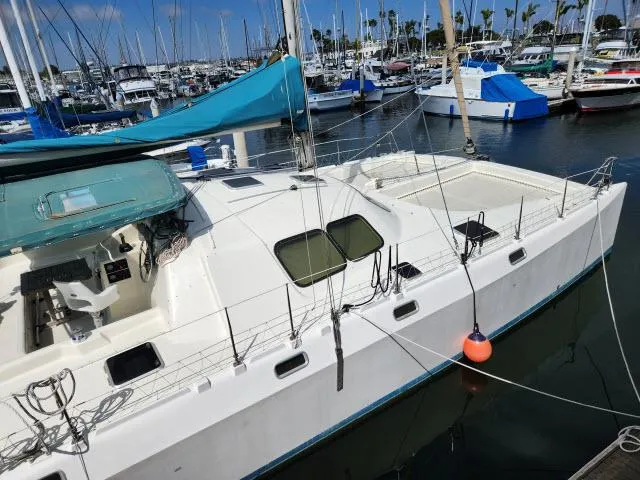 Slide: The Image of 2000 Ocean Cat 49 sailboat docked in a marina with other boats. - 20
