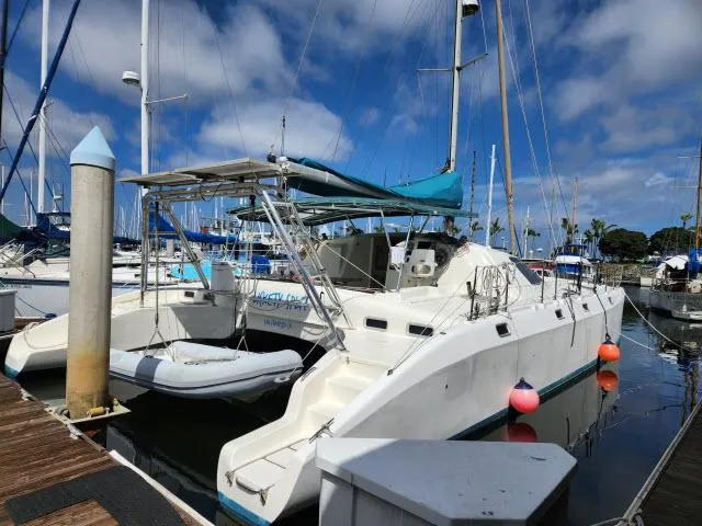 Slide: The Image of Catamaran Ocean Cat 49, 2000 model, docked at marina with blue sky background. - 23