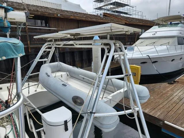 Slide: The Image of Inflatable boat on davit system, docked near Ocean Cat 49 yacht, 2000 model. - 27