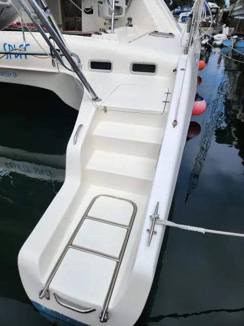 Slide: The Image of Stern view of 2000 Ocean Cat 49 catamaran with boarding ladder and steps. - 28