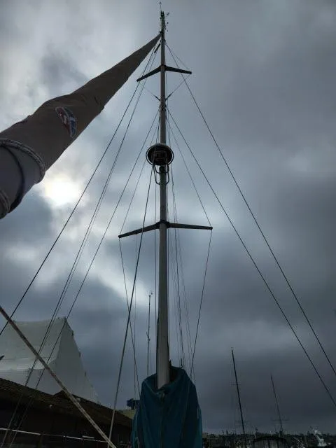 Slide: The Image of Alt text: Ocean Cat 49 sailboat mast against cloudy sky, 2000 model. - 29