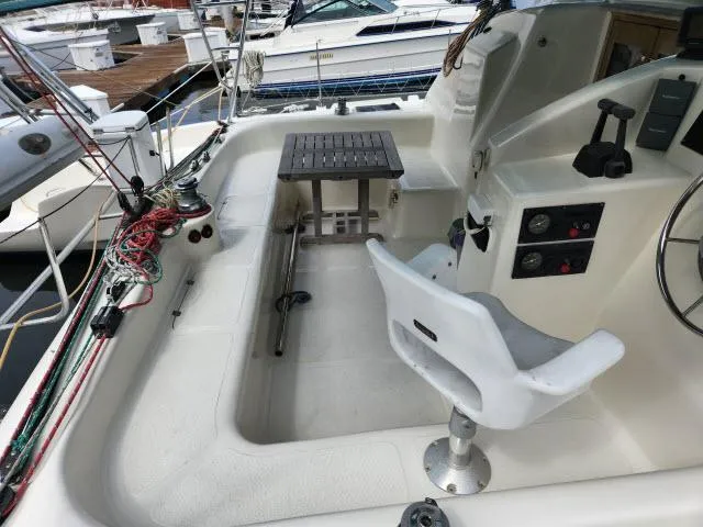 Slide: The Image of Cockpit of a 2000 Ocean Cat 49 sailboat with steering wheel and seating. - 3