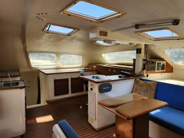 Slide: The Image of Interior of a 2000 Ocean Cat 49 catamaran with skylights and seating area. - 33