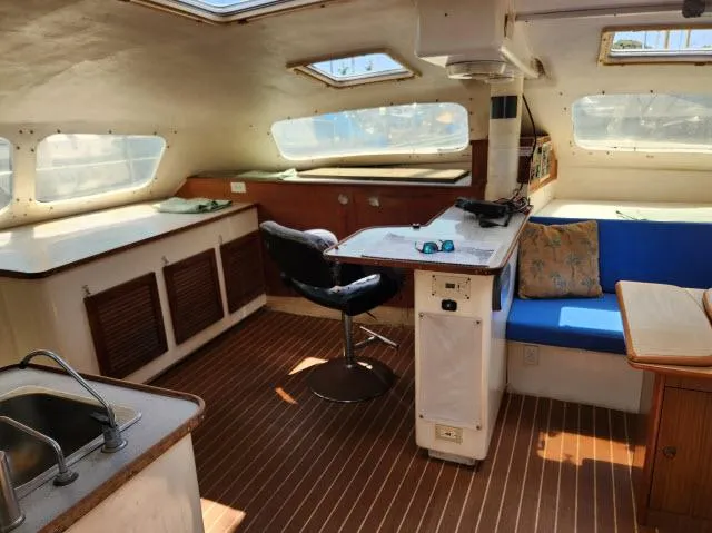 Slide: The Image of Interior of 2000 Ocean Cat 49 catamaran with seating, table, and kitchenette. - 34