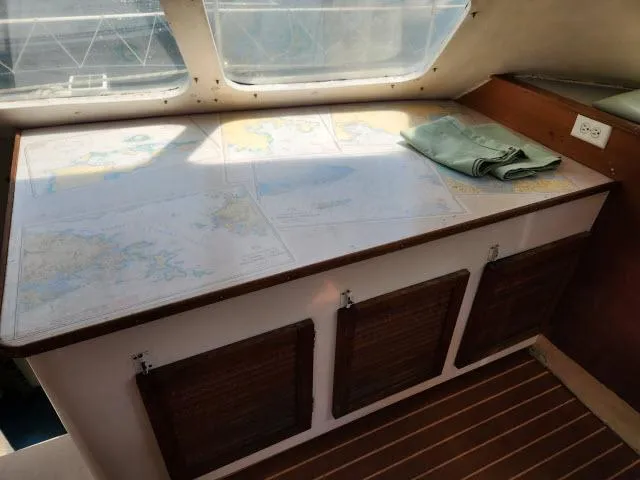 Slide: The Image of Navigation table with maps inside Ocean Cat 49 boat, model year 2000. - 36