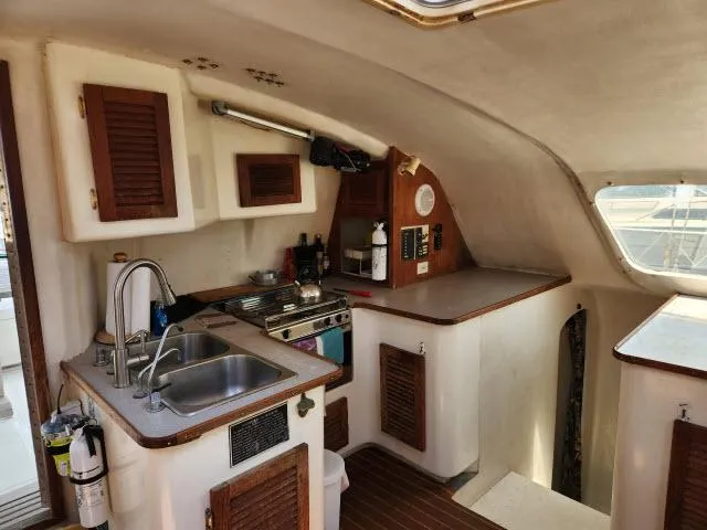 Slide: The Image of 2000 Ocean Cat 49 yacht kitchen with sink, stove, and storage cabinets. - 38