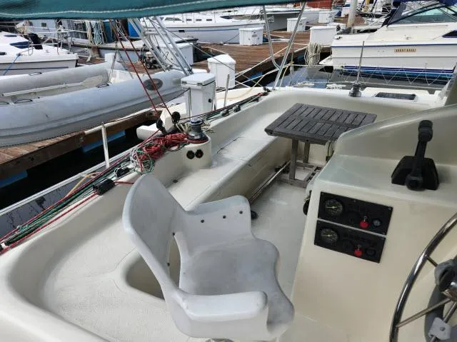 Slide: The Image of Cockpit of a 2000 Ocean Cat 49 sailboat with control panel and seating. - 4