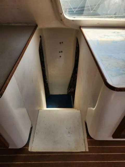 Slide: The Image of Stairway inside 2000 Ocean Cat 49 boat with wooden trim and map table. - 44