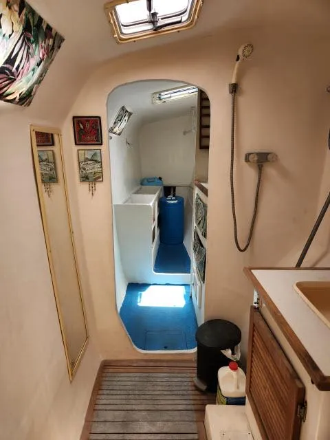 Slide: The Image of Interior of 2000 Ocean Cat 49 sailboat with compact bathroom and storage. - 45