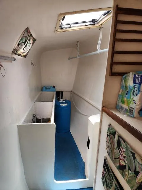Slide: The Image of Interior of 2000 Ocean Cat 49 boat with storage and blue flooring. - 46
