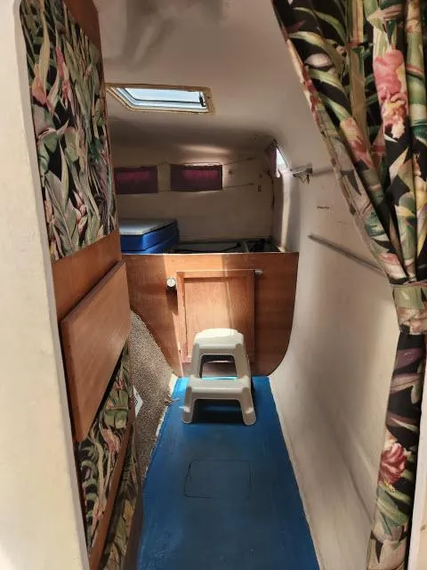 Slide: The Image of Interior of a 2000 Ocean Cat 49 boat with floral curtains and blue flooring. - 47