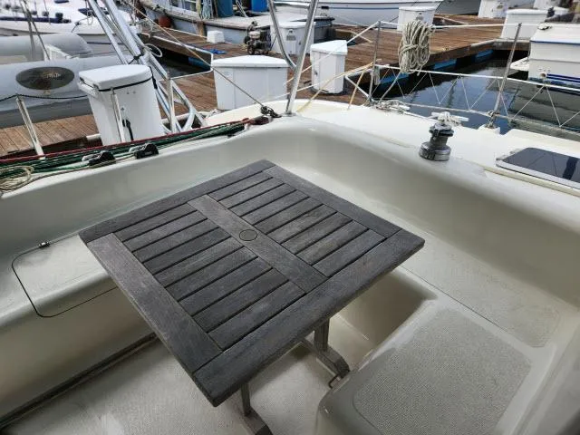 Slide: The Image of Cockpit of 2000 Ocean Cat 49 sailboat with wooden table, docked at marina. - 5
