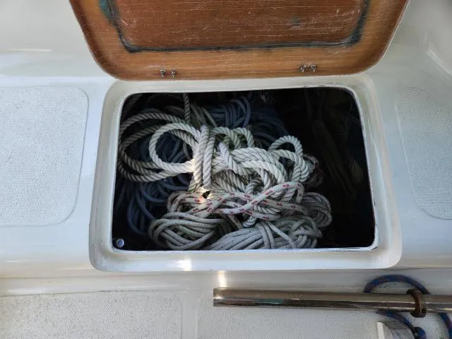 Slide: The Image of Storage compartment with coiled ropes on a 2000 Ocean Cat 49 boat. - 7