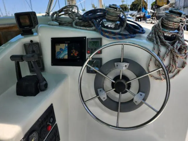 Slide: The Image of Control panel of a 2000 Ocean Cat 49 sailboat with steering wheel and navigation equipment. - 8