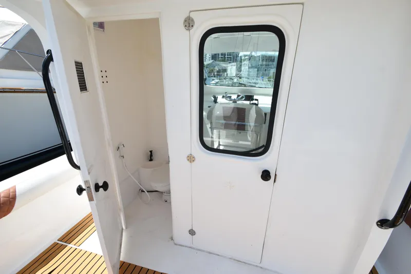 Slide: The Image of 2023 Custom Aljerewy Wave Master boat interior with bathroom and helm station. - 15