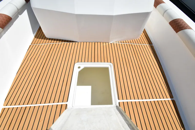Slide: The Image of Deck of 2023 Custom Aljerewy Wave Master boat with wood-like flooring and storage hatch. - 22