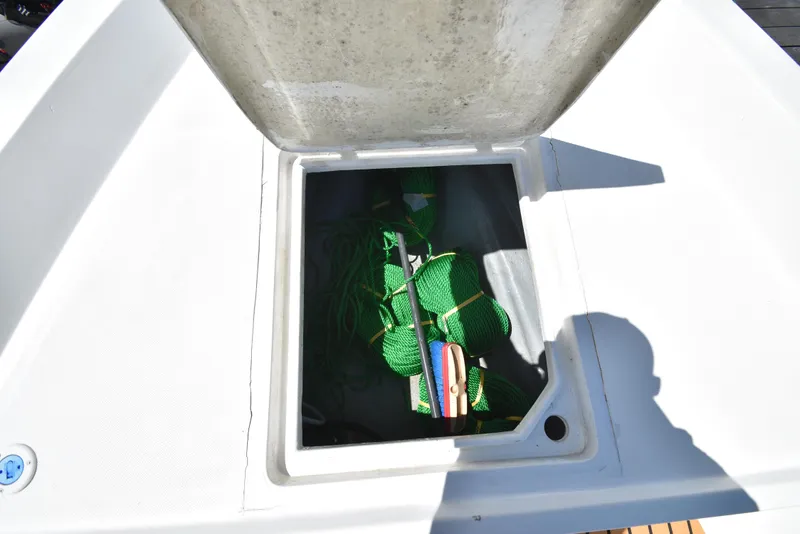 Slide: The Image of Storage compartment of 2023 Custom Aljerewy Wave Master boat with green ropes and cleaning brush. - 24