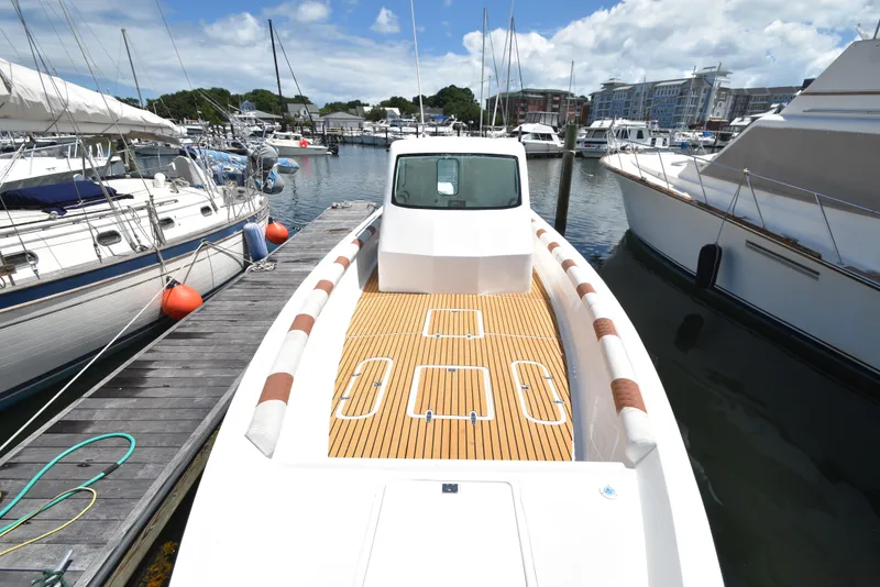 Slide: The Image of Custom 2023 Aljerewy Wave Master boat docked at a marina with other vessels. - 5