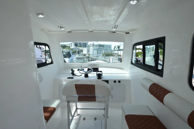 Slide: The Image of Interior of 2023 Custom Aljerewy Wave Master boat with modern helm and seating. - 7