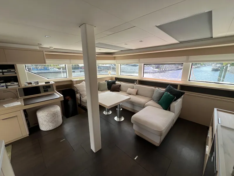 Slide: The Image of Luxurious interior of 2021 Lagoon 55 yacht with modern seating and panoramic windows. - 19