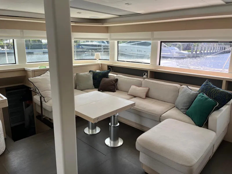 Slide: The Image of Luxurious interior of 2021 Lagoon 55 yacht with spacious seating and large windows. - 20