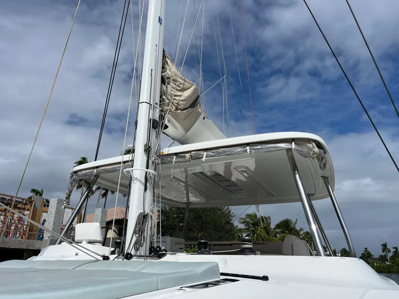 Slide: The Image of Lagoon 55 catamaran, 2021 model, docked under a cloudy sky. - 3