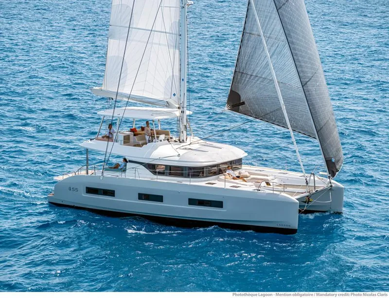 Slide: The Image of 2021 Lagoon 55 catamaran sailing on blue ocean waters. - 4
