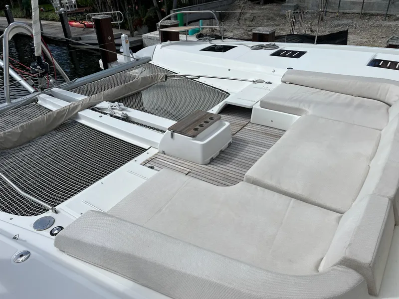 Slide: The Image of Spacious deck of 2021 Lagoon 55 catamaran with comfortable seating and netted lounging area. - 6