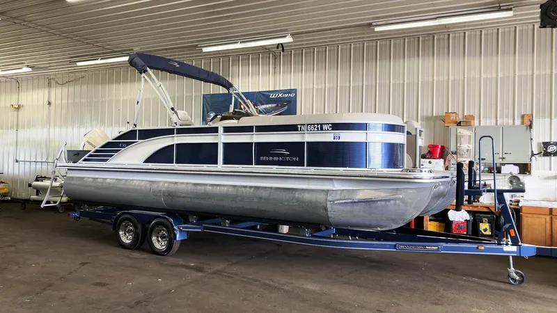 The Image of 2019 Bennington 23 GSB pontoon boat on a trailer in a storage facility. - 0