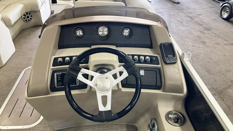 Slide: The Image of 2019 Bennington 23 GSB boat dashboard with steering wheel and control panel. - 10