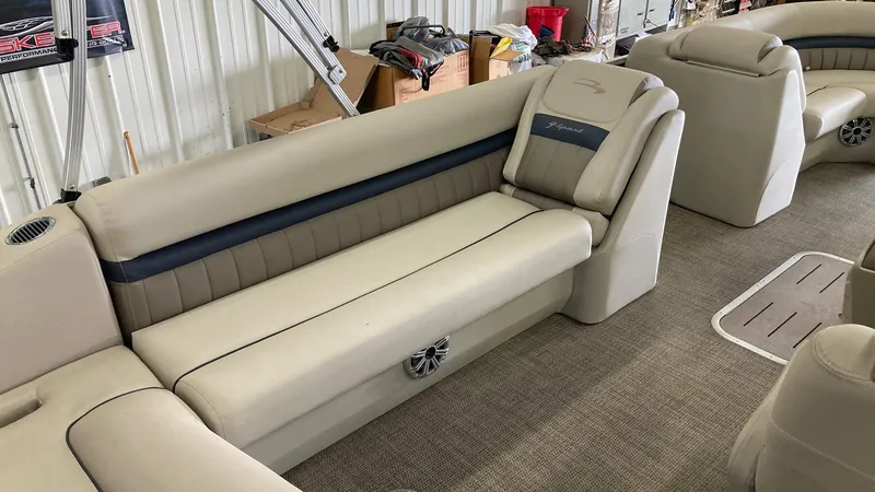Slide: The Image of 2019 Bennington 23 GSB pontoon boat interior with beige seating and blue accents. - 11