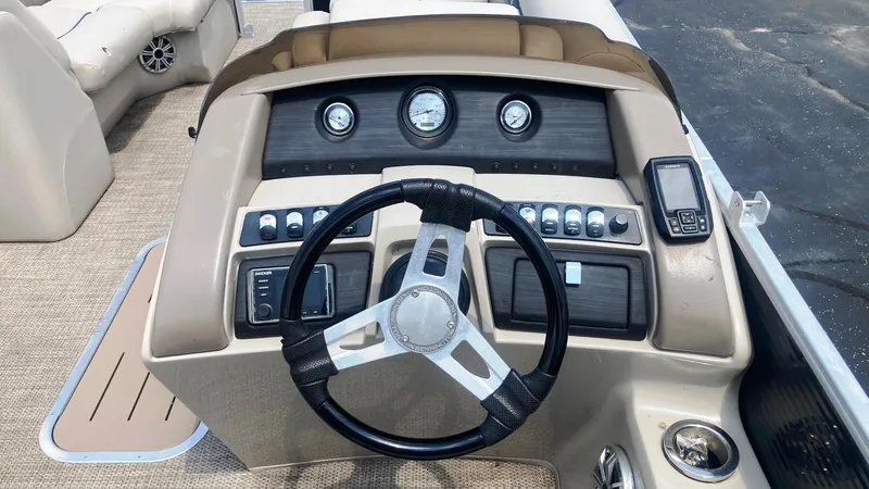 Slide: The Image of 2019 Bennington 23 GSB boat dashboard with steering wheel and control panel. - 8