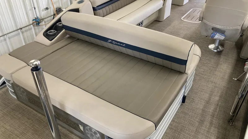 Slide: The Image of 2019 Bennington 23 GSB boat interior with beige seating and cup holders. - 9