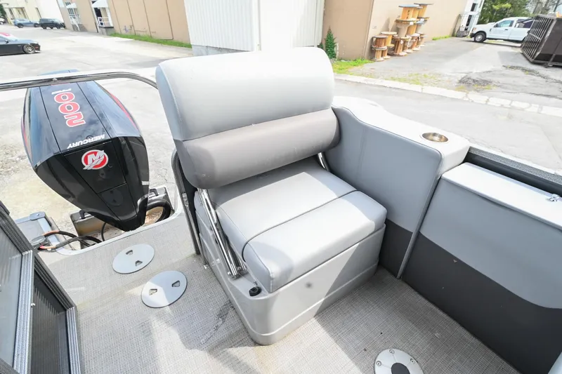 Slide: The Image of 2022 Manitou 25 Oasis VP boat seat with Mercury 100 HP engine in a marina setting. - 12