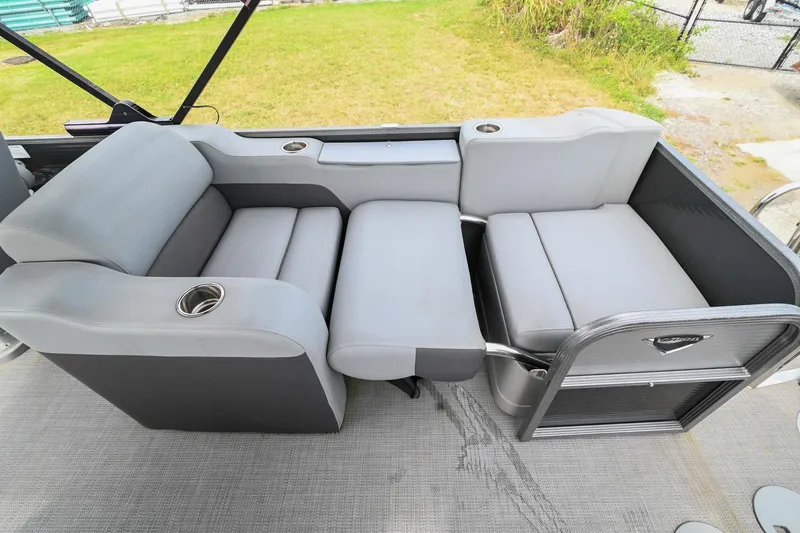 Slide: The Image of 2022 Manitou 25 Oasis VP pontoon boat with gray seating and cup holders. - 14