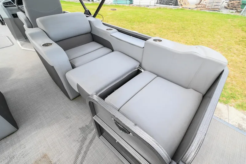 Slide: The Image of Luxurious seating on 2022 Manitou 25 Oasis VP pontoon boat, featuring plush gray upholstery. - 15