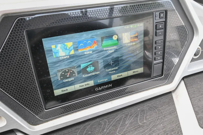 Slide: The Image of Garmin display on 2022 Manitou 25 Oasis VP boat dashboard showing navigation options. - 24