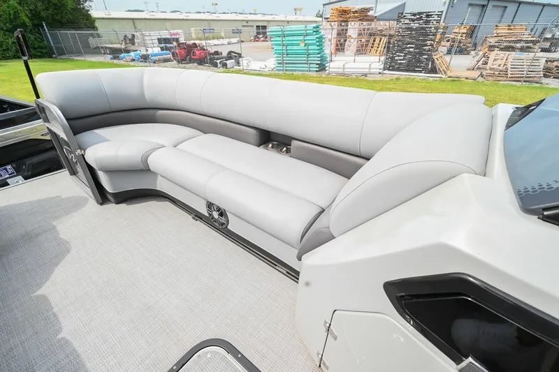 Slide: The Image of 2022 Manitou 25 Oasis VP boat with spacious gray seating and modern design. - 31