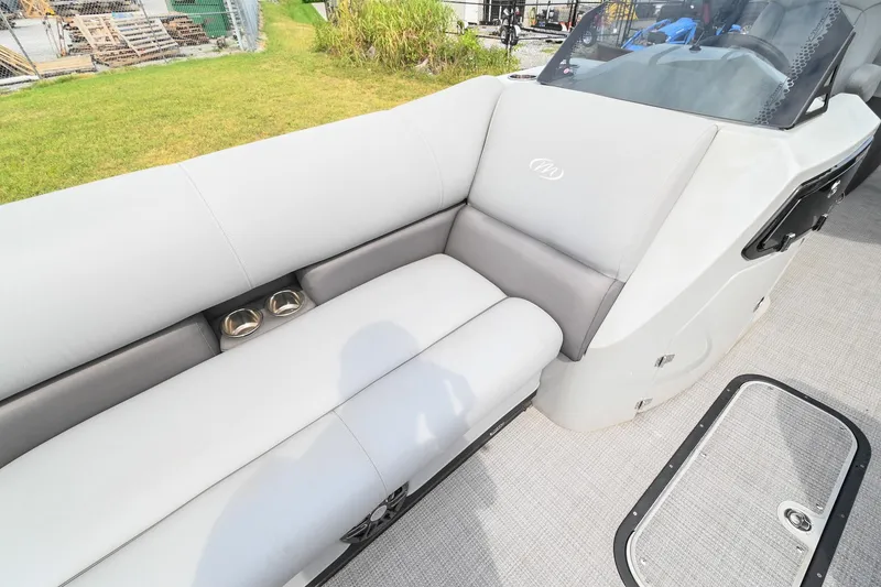 Slide: The Image of 2022 Manitou 25 Oasis VP boat interior with gray seating and cup holders. - 34