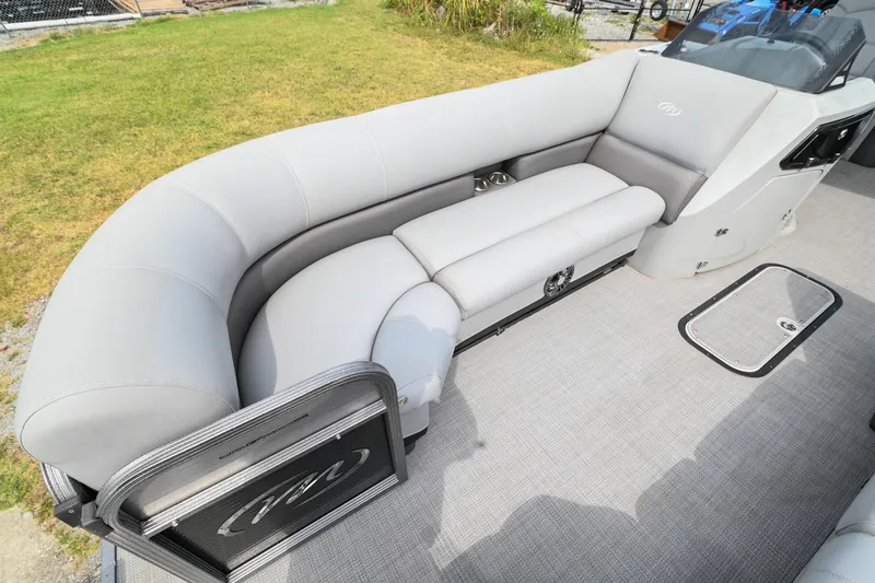 Slide: The Image of 2022 Manitou 25 Oasis VP pontoon boat with spacious gray seating and modern design. - 36