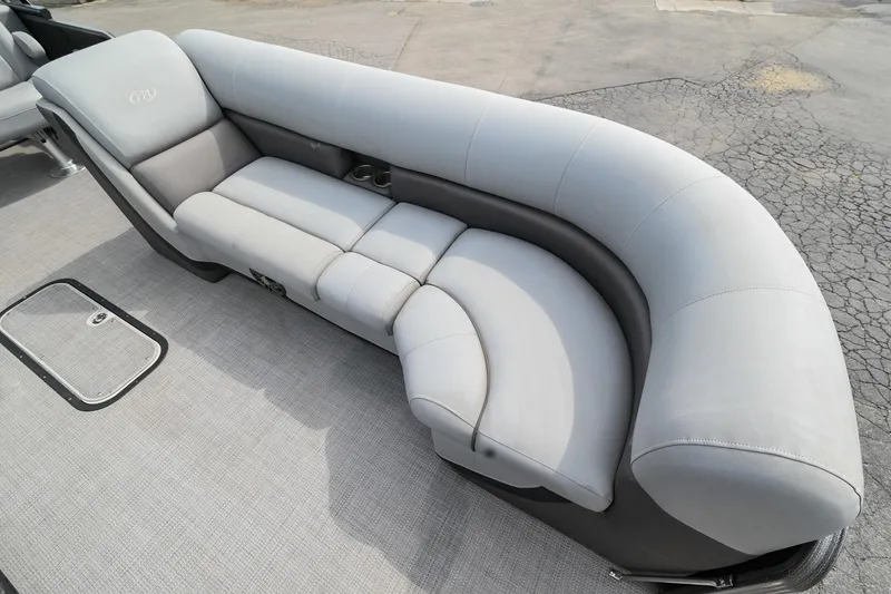 Slide: The Image of 2022 Manitou 25 Oasis VP boat with luxurious gray seating on deck. - 37