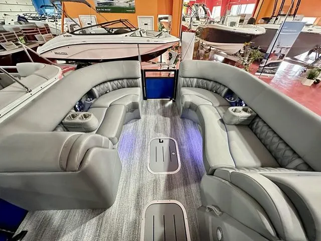 Slide: The Image of Interior of 2025 Bennington 24 LXSBA boat with control panel and warning labels. - 12