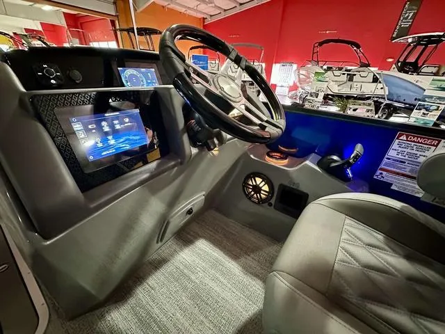 Slide: The Image of 2025 Bennington 24 LXSBA boat interior with modern helm and luxurious seating. - 13