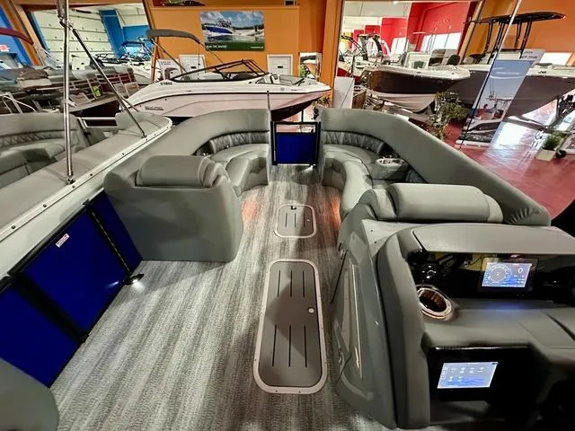 Slide: The Image of 2025 Bennington 24 LXSBA pontoon boat interior with gray seating and blue LED lighting. - 15