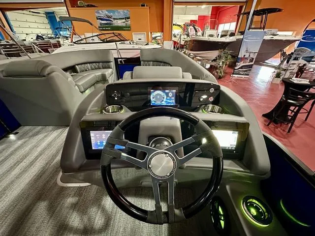 Slide: The Image of 2025 Bennington 24 LXSBA pontoon boat displayed in a showroom. - 18