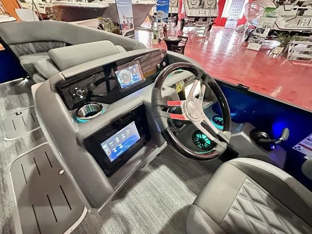 Slide: The Image of 2025 Bennington 24 LXSBA boat with a 350 V6 engine in a showroom. - 19